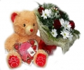 Teddy bear with chocolate and flowers